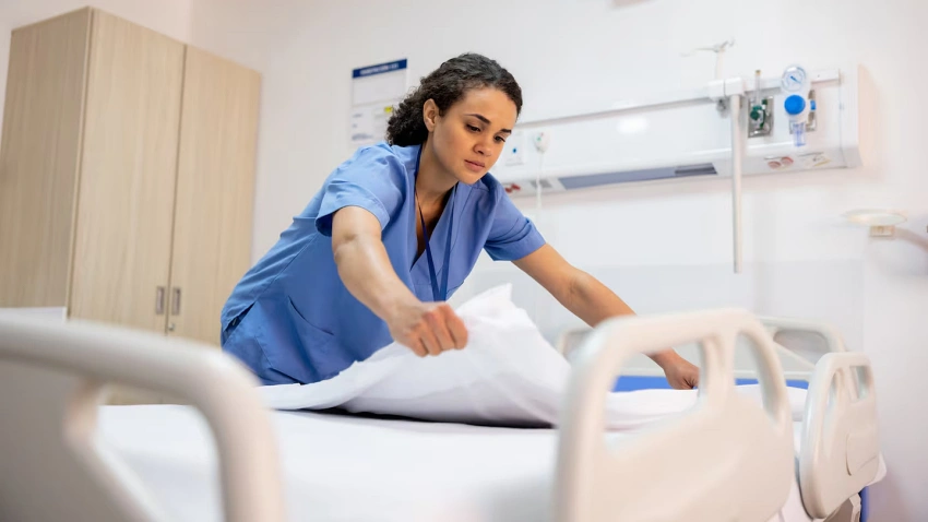 Nurse getting the bed ready